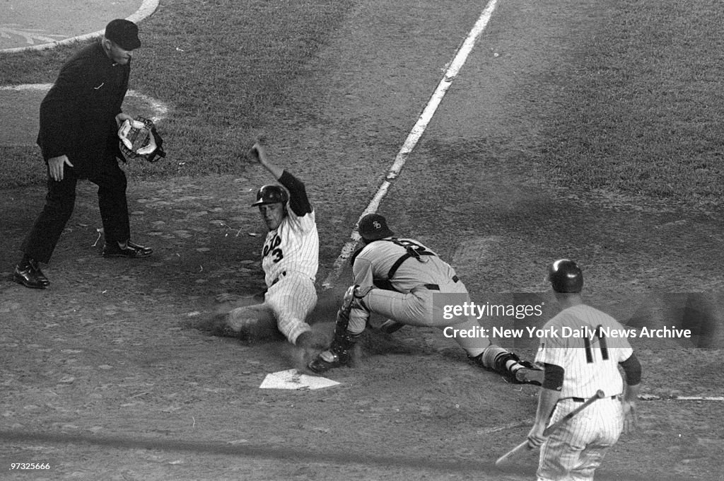 New York Mets' Bud Harrelson slides toward plate in second i