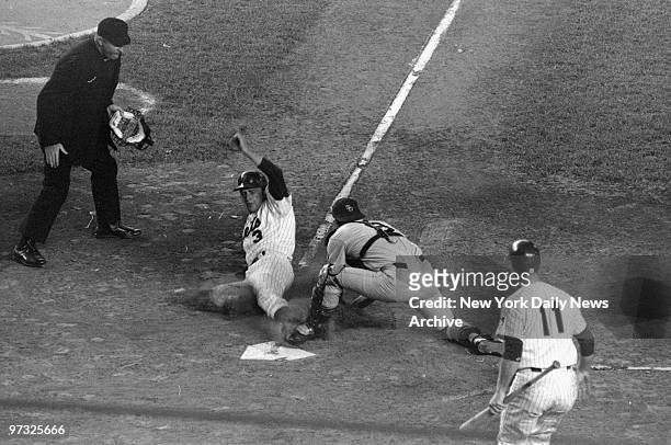 New York Mets' Bud Harrelson slides toward plate in second inning at Shea Stadium, but mainly into San Diego Padres' catcher Chris Cannizzaro. Plate...