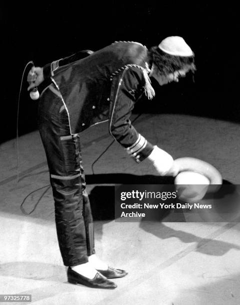 Michael Jackson takes his hat off the Pepsi crowd at the New York State Theater. He burned his head while making a Pepsi commercial.,