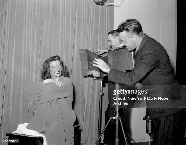 Katherine Hepburn has her picture taken in the Daily News One and Three Color Studio.