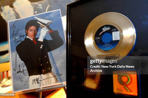 Michael Jackson's gold "Thriller" single and an autographed photo are previewed at Guernsey's auction house on E. 73rd St. They will auctioned off...