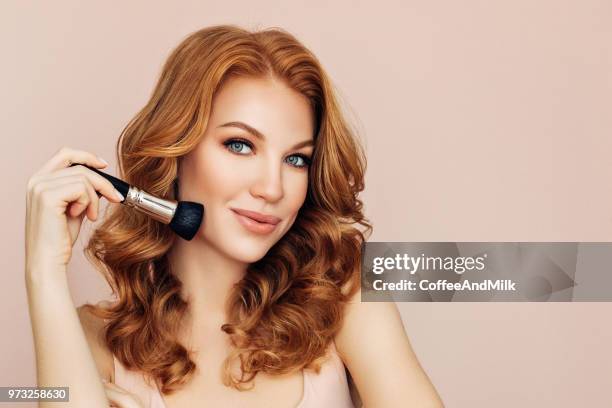 woman with a brush for make-up powder - coffeeandmilk stock pictures, royalty-free photos & images