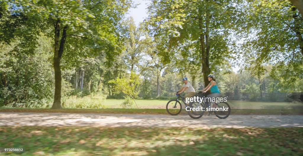 Family riding bicycle in park