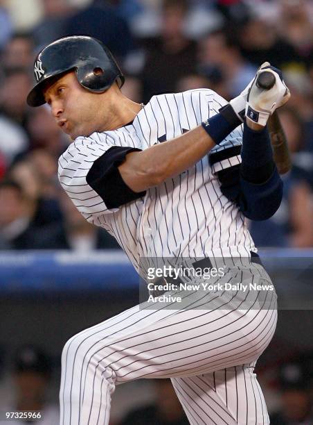 Derek Jeter connects for an infield single in the second inning of a game against the Boston Red Sox at Yankee Stadium, to pass Joe DiMaggio for...