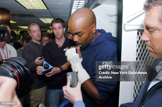 New York Mets' Carlos Delgado speaks to media as he and his teammates clean out their lockers at Shea Stadium following yesterday's loss, in which...