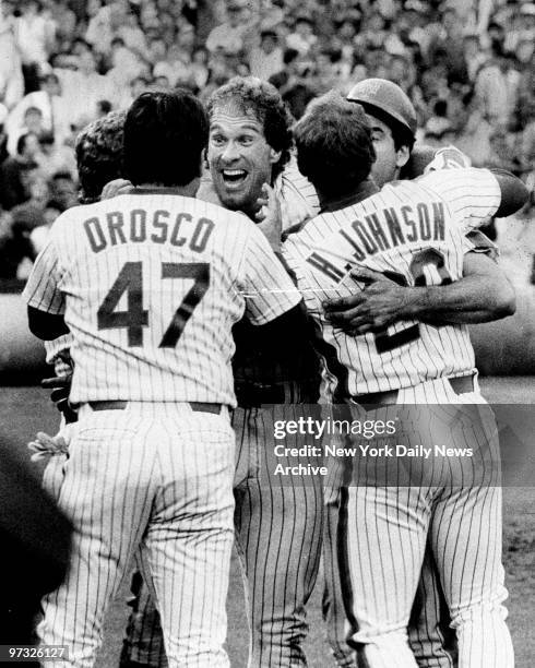 New York Mets' catcher Gary Carter celebrates with teammates after his 12th-inning single drove home the winning run to beat the Houston Astros, 2-1,...