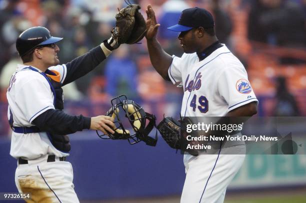 New York Mets' catcher Jason Phillips gives closer Armando Benitez a high five after the Mets defeated the Montreal Expos, 3-1, at Shea Stadium....