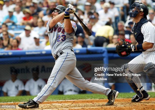 New York Mets' catcher Jason Phillips slugs a sacrifice fly to center field to score Mike Cameron in the second inning of game against the New York...