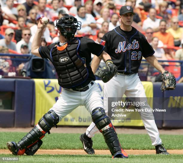 New York Mets' catcher Jason Phillips throws out a runner as pitcher Steve Trachsel looks on in a game against the Atlanta Braves at Shea Stadium....