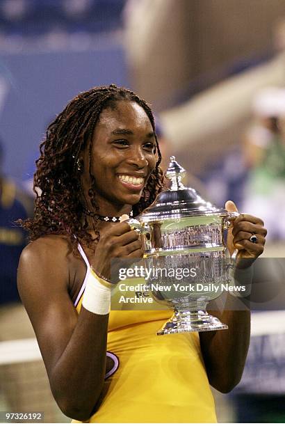 Venus Williams shows off her trophy after beating Lindsay Davenport, 6-4, 7-5, in the women's final game at the U.S. Open in Flushing Meadows.