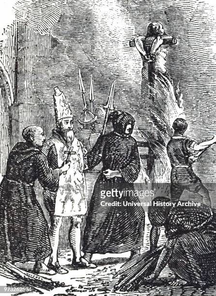 Woodblock engraving depicting a victim of the Spanish Inquisition being led to the stake wearing a San Benito, a linen overall painted with figures...