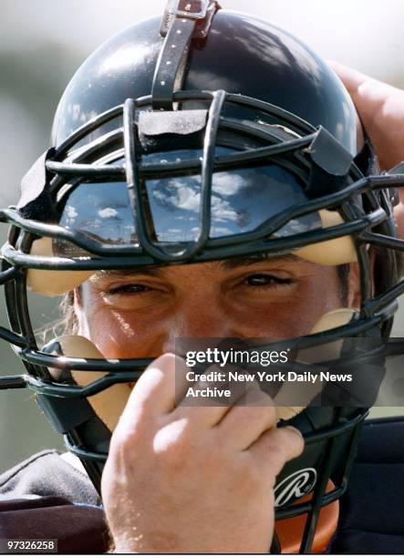 New York Mets' catcher Mike Piazza adjusts his facemask at spring training camp.