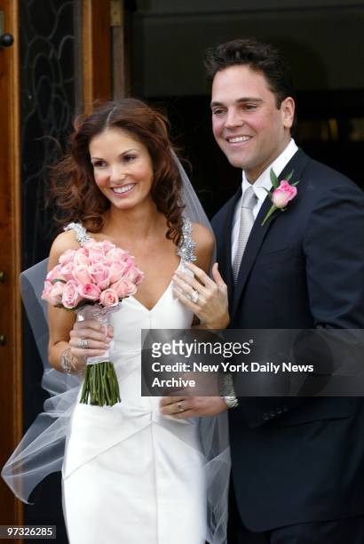 New York Mets' catcher Mike Piazza and his bride, Alicia Rickter, greet friends and family as they leave St. Jude's Catholic Church in Miami after...