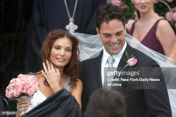 New York Mets' catcher Mike Piazza and his bride, Alicia Rickter, greet friends and family as they leave St. Jude's Catholic Church in Miami after...