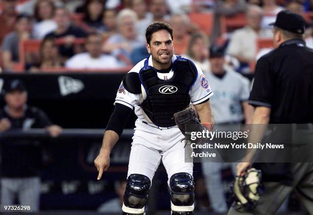 New York Mets' catcher Mike Piazza argues safe call with umpire after trying unsuccessfully to tag out Florida Marlins' Cliff Floyd, who went on to...