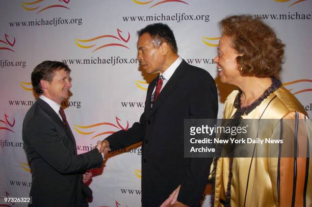 Michael J. Fox greets co-chairs Muhammad Ali and his wife, Lonnie, as they arrive for "A Funny Thing Happened on the Way to Cure Parkinson's..." at...