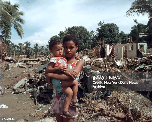 Kathy Reyes and her sister Gracie, search through area that used to be their home in the aftermath of Hurricane Georges in Santo Domingo in the...