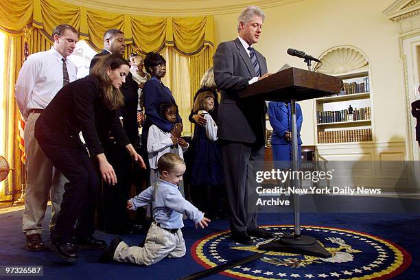 Katie Banks reaches for her son, Collin, who's not paying much attention to President Bill Clinton in the Oval Office. Collin's father, Eric , and...