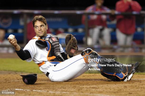 New York Mets' catcher Mike Piazza shows the home plate umpire he still has possession of the ball after placing the tag on Philadelphia Phillies'...