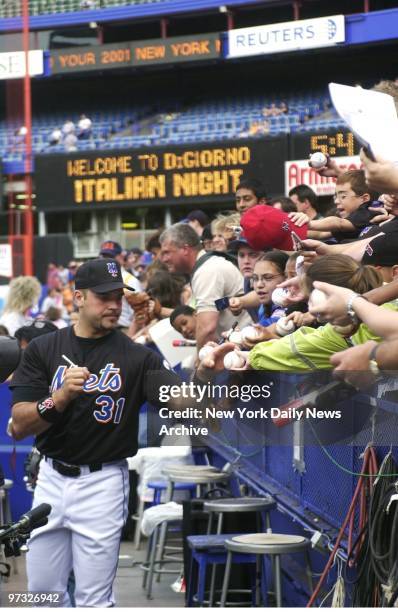 New York Mets' catcher Mike Piazza signs autographs for fans before start of game against the Boston Red Sox. The Mets lost to the Red Sox, 3-1.