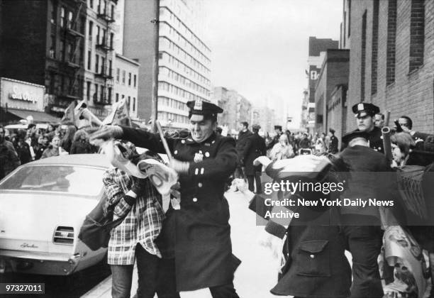 Women pickets and police struggle outside the Women's House of Detention, Greenwich Village. Protestors for YAWF wanted prisoners released and equal...