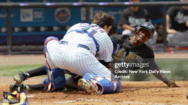 New York Mets' catcher Mike Piazza tags Florida Marlins' outfielder Juan Pierre out as he slides into home in the third inning of game at Shea...