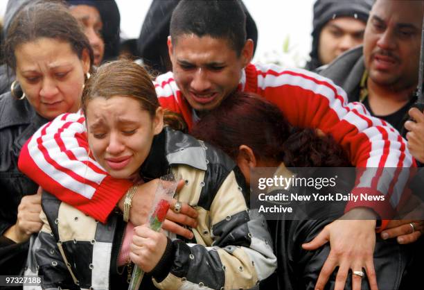 Nixzmary Brown's uncle, Omar Santiago, puts his arms around her cousin Jasmin Villanueva and her grandmother Maria Gonzalez as Nixzmary's casket is...