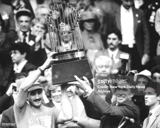Keith Hernandez and Gary Carter hoist the World Series trophy at City Hall after New York Mets' parade.