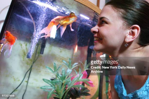 Sutton Foster gazes lovingly at one of her seven pet goldfish in her prewar one-bedroom apartment in midtown Manhattan. Many of her fish - named...