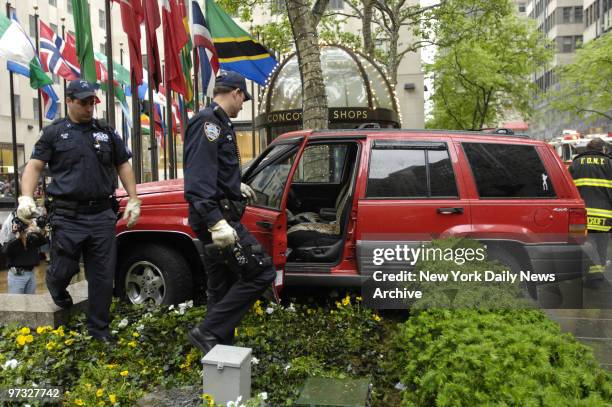 Jumps sidewalk and lands in planter overlooking Rockefeller Center Ice Skating Rink at W49St.. Pedestrians were injured and a woman inside the SUV.