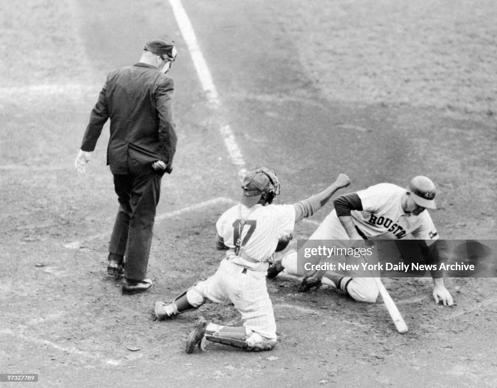 Norm Larker hits the dirt after a close pitch from New York