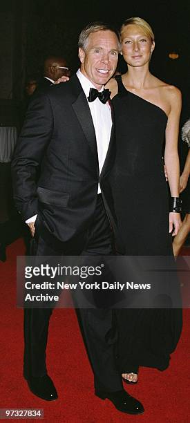 Designer Tommy Hilfiger and model Maggie Rizer arrive at the Metropolitan Museum of Art for the opening of "Jacqueline Kennedy: The White House...