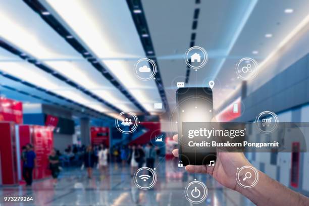 hand holding mobile phone with icons. concept of business and technology communication in the network. - app store stock-fotos und bilder