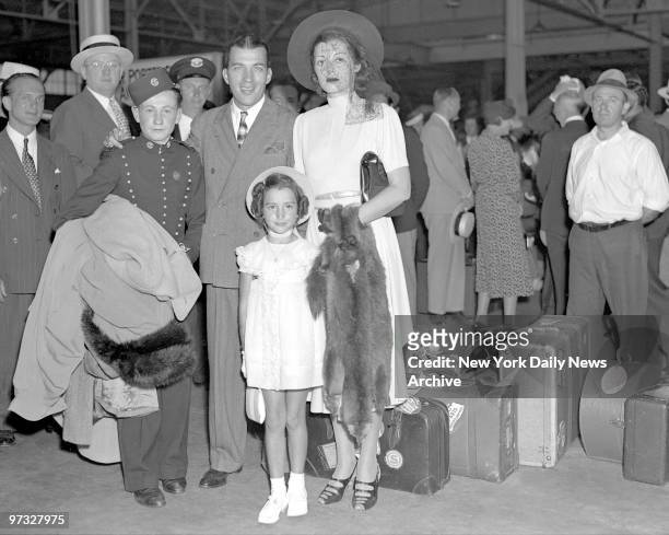 Sylvia and Ed Sullivan with daughter Betty arrive home from Europe on Normandie on his birthday. Two decorated excursion boats and an plane met him...
