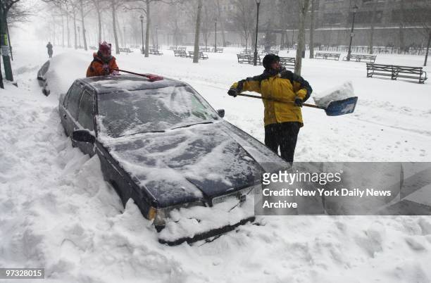 Sylvia Gerber and Ashley dig their car out of the snow at Dag Hammarskjold Plaza as the blizzard of 2003 dumps almost two feet of snow on the city.