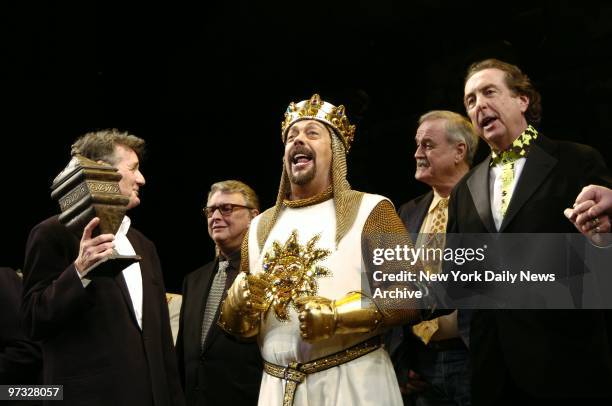 Michael Palin holds an urn representing Graham Chapman, who died in 1989, as he joins director Mike Nichols, Tim Curry, John Cleese, and Eric Idle...