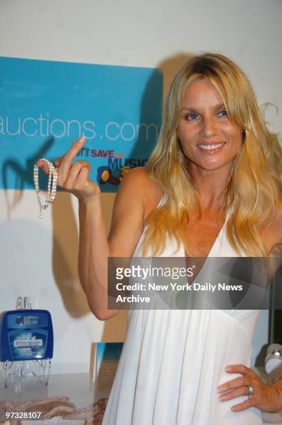 Desperate Housewives star Nicollette Sheridan shows off a bracelet from a summer survival kit she donated to be auctioned off during a benefit for...
