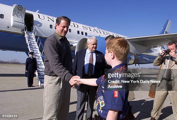 Vice President Al Gore is greeted by scout Seth Diewold on arrival at Burlington, Iowa, airport. Iowa Rep. Leonard Boswell joins the campaigning VP.