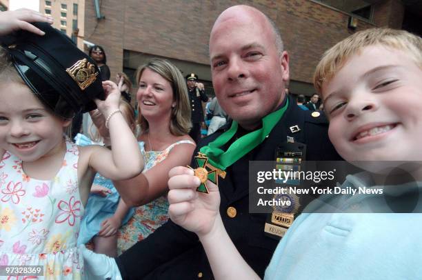 Det. Kevin Keuchler of ESU 1 is joined by his wife, Karen, daughters Emily and Kaleigh and son Tim after receiving the Combat Cross, the second...