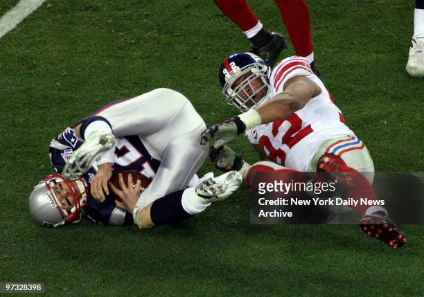 Michael Strahan sacks Tom Brady during the 3rd quarter., Superbowl XLII between the New York Giants and the New England Patriots at University of...