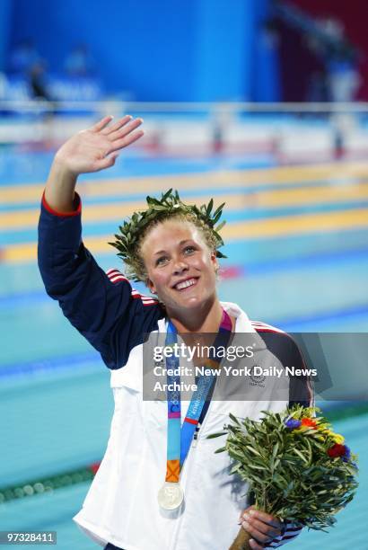 Swimmer Jenny Thompson of the United States waves to fans after her team won silver medals in the 4 x 100 meter freestyle relay at the Aquatic Center...