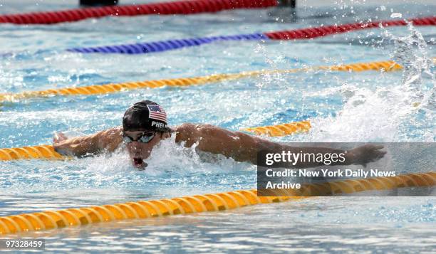 Swimmer Michael Phelps of the U.S. Competes in the 100-meter butterfly final at the Aquatic Center during the 2004 Summer Olympic Games in Athens....