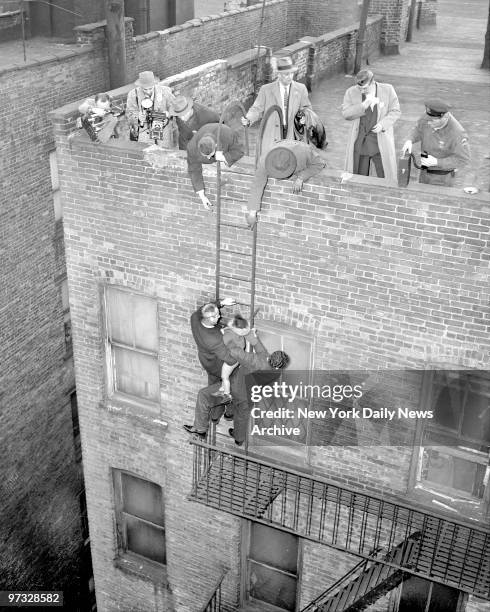 Detective James Fleming carries Antonia Archeval whom he rescued from August Robles' gunfire up to fire escape to roof of 67 E. 112th Street. Fleming...