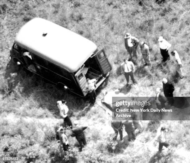 Detectives and FBI agents surround the covered remains of Peter Weinberger lying beside police van. The discovery of the body crushed the final hopes...