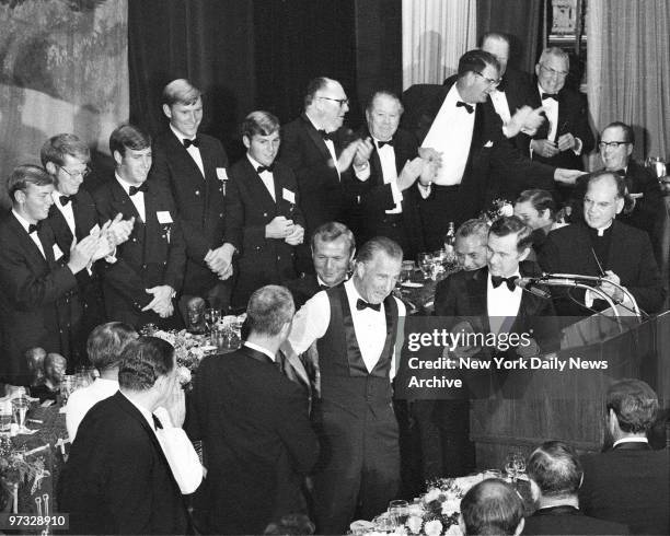 Vice President Spiro Agnew in shirtsleeves, dons blazer as honorary member of All American Collegiate Golf Team during sixth annual dinner last night...