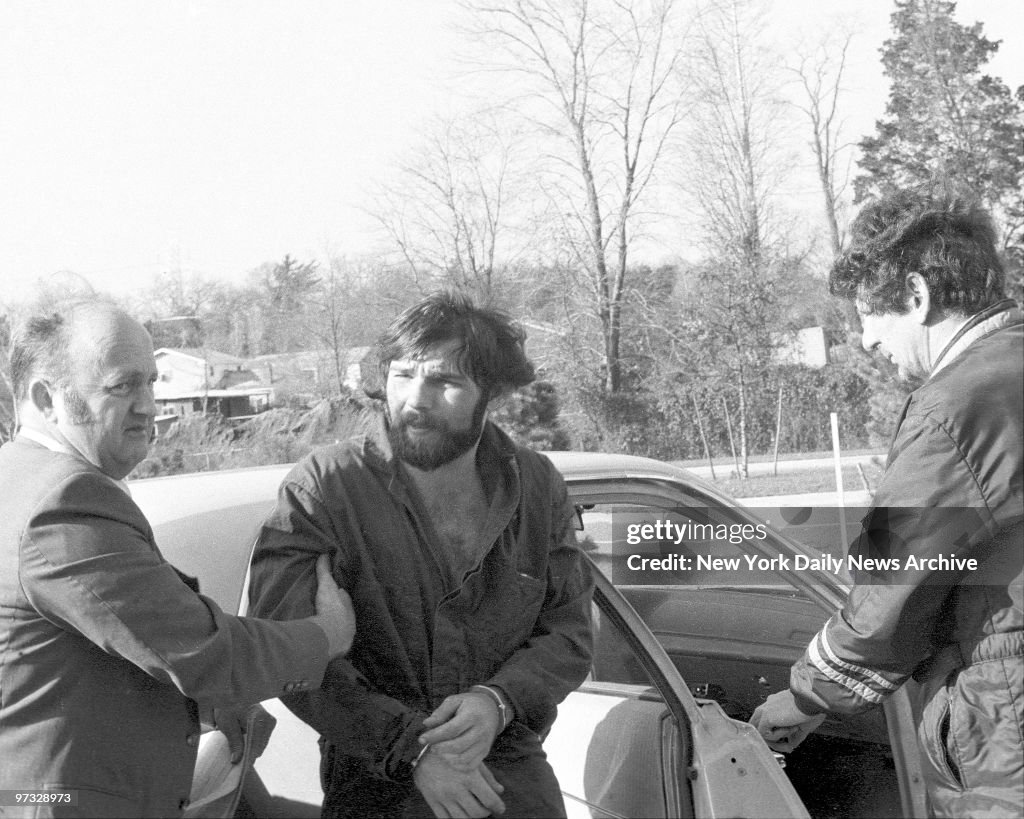 Detectives escort Ronald DeFeo, Jr. as they arrive at Long I