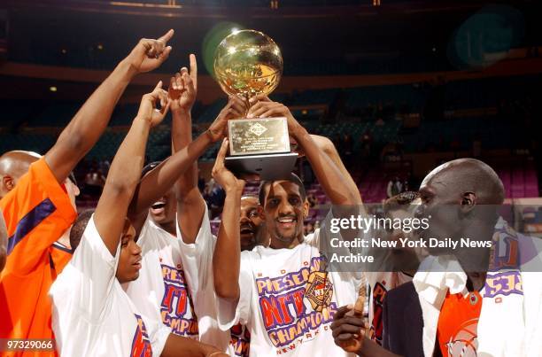 Syracuse's Preston Shumpert holds up championship trophy with teammates after the Syracuse Orangemen beat the Wake Forest Demon Deacons, 74-67, in...