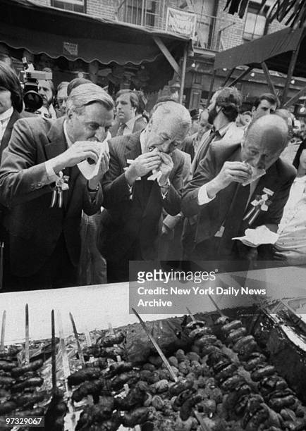 Vice President Walter Mondale, Gov. Hugh Carey, and Mayor Ed Koch sample sausage and pepper sandwiches at the San Gennaro festival on Mulberry St.