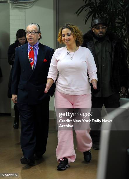 Tabitha Mullings walks with her llawyer, Attorney Sanford Rubenstein, left, and her fiancee, Moe Davis, right, February 5, 2009 at the Rusk Institute...