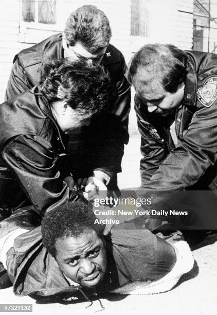 Tactical Narcotics police of the 75th Precinct, Al Hermann, Robert Romano and Leslie Crane , tackle a suspected drug buyer in a dope raid at 209...